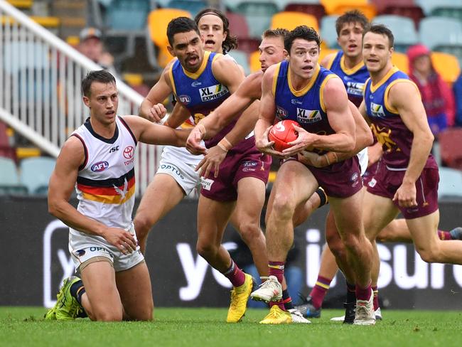 Lachie Neale (centre) of the Lions in action during the Round 4 AFL match between the Brisbane Lions and the Adelaide Crows at The Gabba in Brisbane, Sunday, June 28, 2020 (AAP Image/Darren England) NO ARCHIVING, EDITORIAL USE ONLY