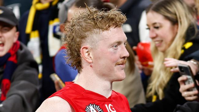 MELBOURNE, AUSTRALIA - APRIL 24: Clayton Oliver of the Demons celebrates with fans during the 2024 AFL Round 07 match between the Richmond Tigers and the Melbourne Demons at the Melbourne Cricket Ground on April 24, 2024 in Melbourne, Australia. (Photo by Michael Willson/AFL Photos via Getty Images)