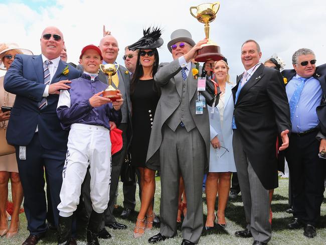 Jockey Kerrin McEvoy with owner Lloyd Williams and their winning trophies. Picture: Getty Images