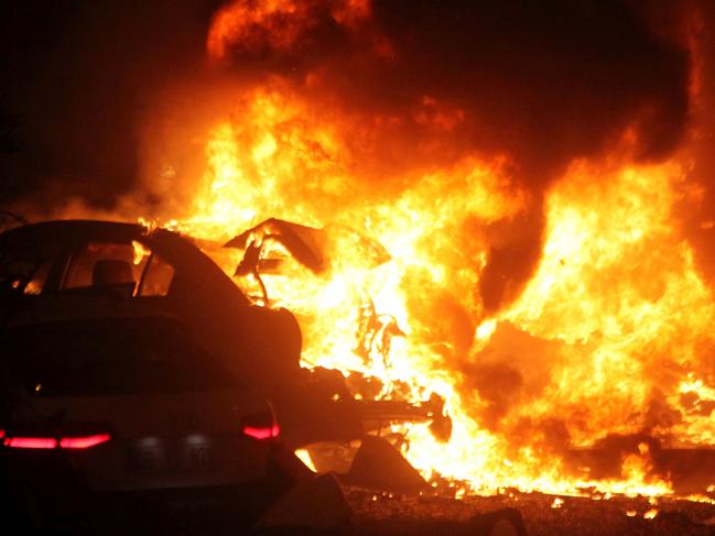 This picture taken on March 13, 2016, shows a burning car after a blast in Ankara. An explosion ripped through a busy square in central Ankara on March 13, killing 27 people and wounding 75 more, with local media reports describing it as an attack. Ambulances rushed to the scene of the explosion on Kizilay square, a key shopping and transport hub close to the city's embassy area. / AFP PHOTO / MEHMET OZER