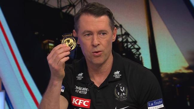 Craig McRae with his premiership medal.