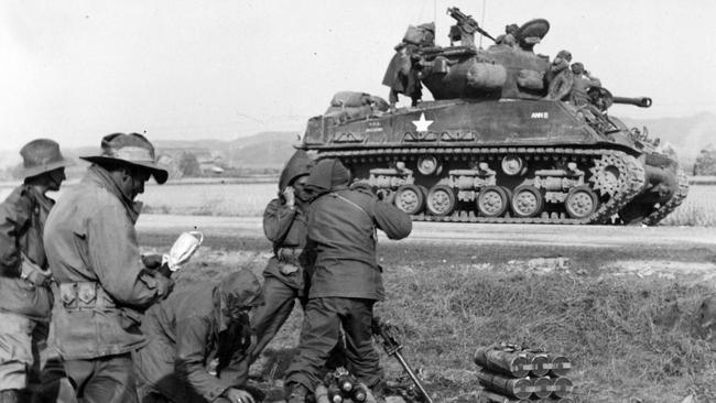 A mortar crew in action during an Australian attack on a North Korean position, with an American Sherman tank in support. Picture: SLV