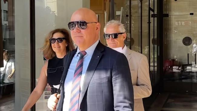 Remo Cignetti (back right) appeared in Downing Centre Local Court on Friday.