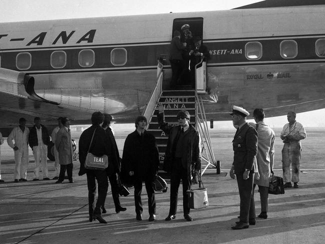 John Lennon of the Beatles acknowledges the roar of the Brisbane supporters before the group entered their aircraft at Eagle Farm Airport. Picture: News Corp
