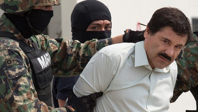 Drug cartel kingpin ... El Chapo Guzman stares down the press, escorted by the navy, around the time of his arrest last year before his eventual prison escape in July 2015. Picture: Susana Gonzalez/Bloomberg