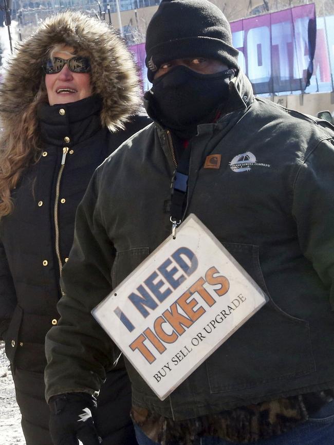 A bundled-up man braves subzero temperatures looking for tickets around the site of the Super Bowl. Picture: AP.