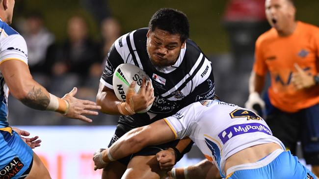 Joseph Leilua is wrapped up by the Titans’ defence. Picture: Robb Cox/NRL Photos