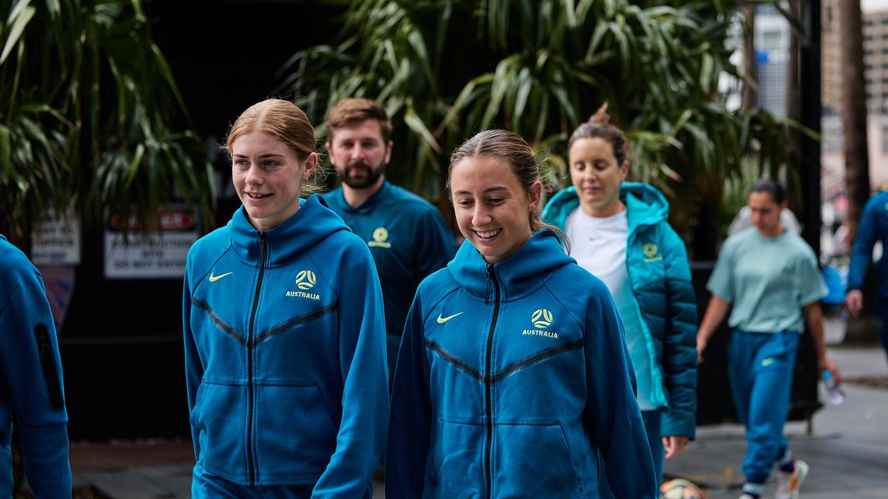 Quarter-final hero Cortnee Vine (left) and Clare Wheeler take part in the walk with their Matildas teammates around Darling Harbour. Photo: Ann Odong, FFA