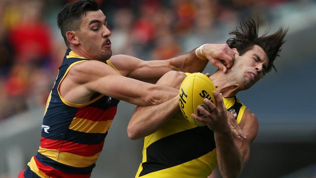 Alex Rance marks despite enormous pressure from Adelaide skipper Taylor Walker. Picture: Getty