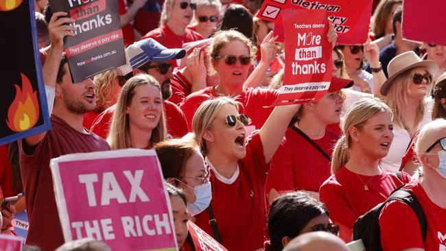 School teachers march along Macquarie St towards NSW Parliament on May 4, 2022 in Sydney, Australia. Tens of thousands of teachers across NSW are taking part in a 24-hour strike to protest pay and staff shortages. (Photo by Jenny Evans/Getty Images)