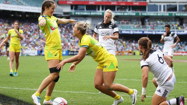 Emma Tonegato and Dominique Du Toit celebrate a win at last year’s Sydney Sevens.