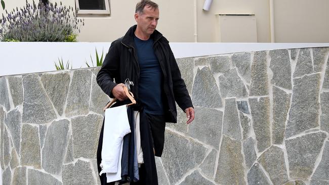 Financier Charlie Aitken picking up his clothes from estranged wife Ellie. Picture: Matrix