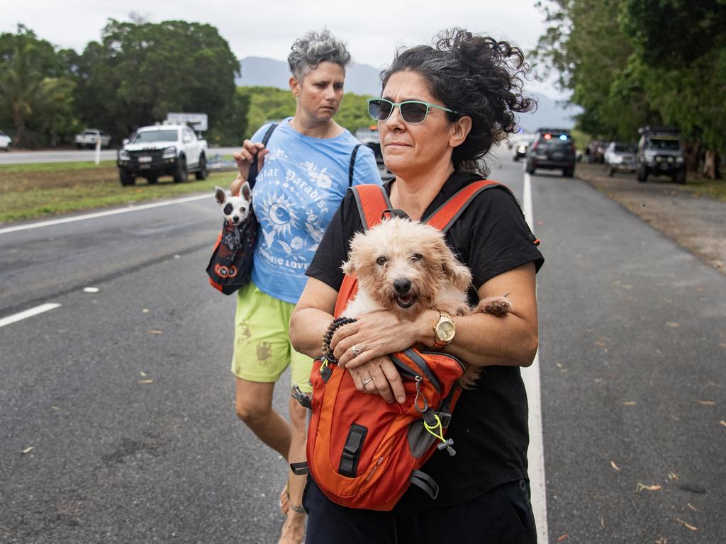 A family evacuates from Holloway Beach with their pets, who seem none the wiser. Picture: Brian Cassey/NCA Newswire