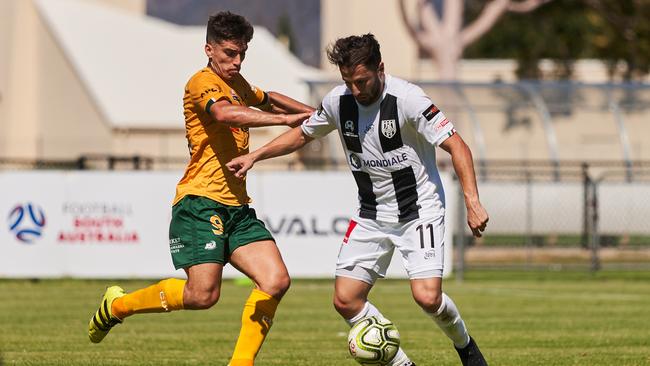 Cumberland United’s Juan Gutierrez takes on Adelaide City’s Nic Bucco during an NPL match in February this year. Picture: Matt Loxton