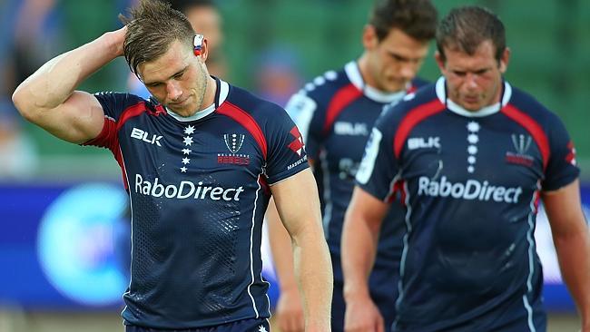 Melbourne Rebels back Jason Woodward walks disconsolately from the field after the Force loss.