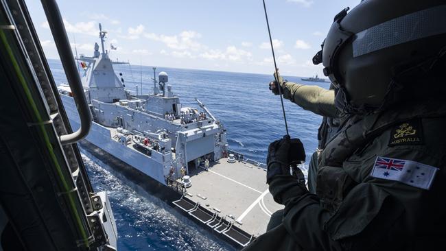 Petty Officer Aircrewman Raymond Solomon gives a thumbs up to the crew of Royal Malaysian Navy Ship KD Selangor during a cooperative activity with HMAS Parramatta. Picture: Defence Department