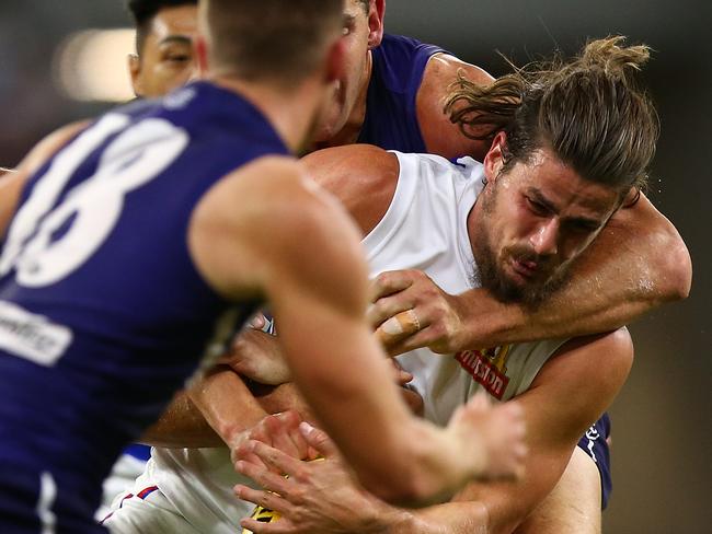 PERTH, AUSTRALIA - APRIL 21: Tom Boyd of the Bulldogs gets tackled during the round five AFL match between the Fremantle Dockers and the Western Bulldogs at Optus Stadium on April 21, 2018 in Perth, Australia.  (Photo by Paul Kane/Getty Images)