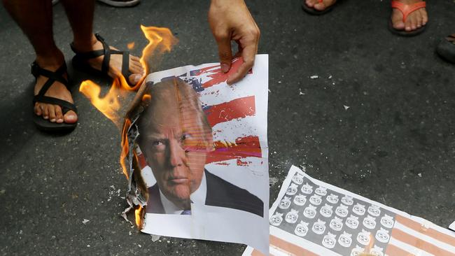 Protesters are burning effigies and photos of Donald Trump around the world. Picture: AFP Photo/Bullit Marquez