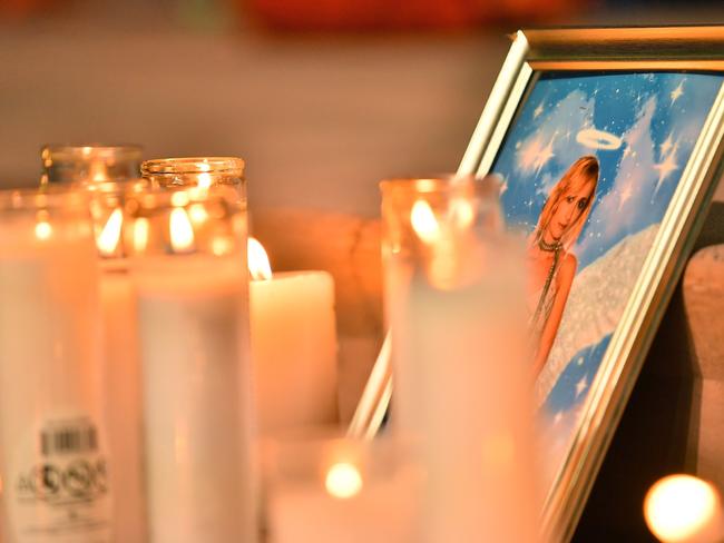 Candles are placed in front of a photo of cinematographer Halyna Hutchins during a vigil in her honour in Albuquerque, New Mexico. Picture: Getty Images/AFP