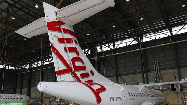 Workers give one of Virgin Australia's ATR72 regional fleet a new coat of polymer from Permagard.