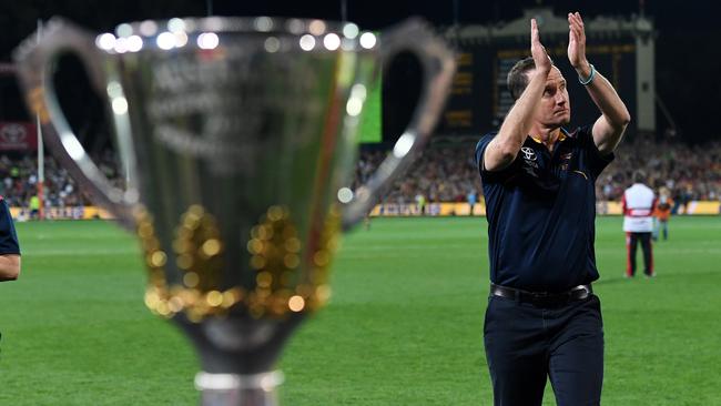 Coach Don Pyke walks past the premiership cup as he thanks fans after the Crows’ 61-point victory. Picture: AAP Image/Tracey Nearmy