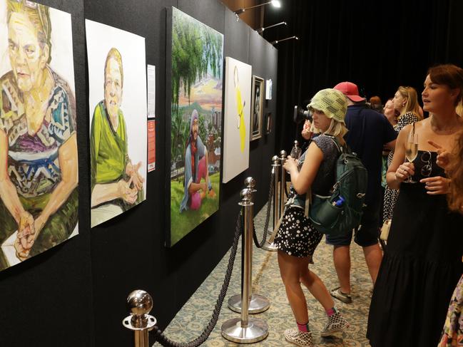 Patrons attend the Brisbane Portrait Prize launch at Howard Smith Wharves on Sunday. Picture Lachie Millard