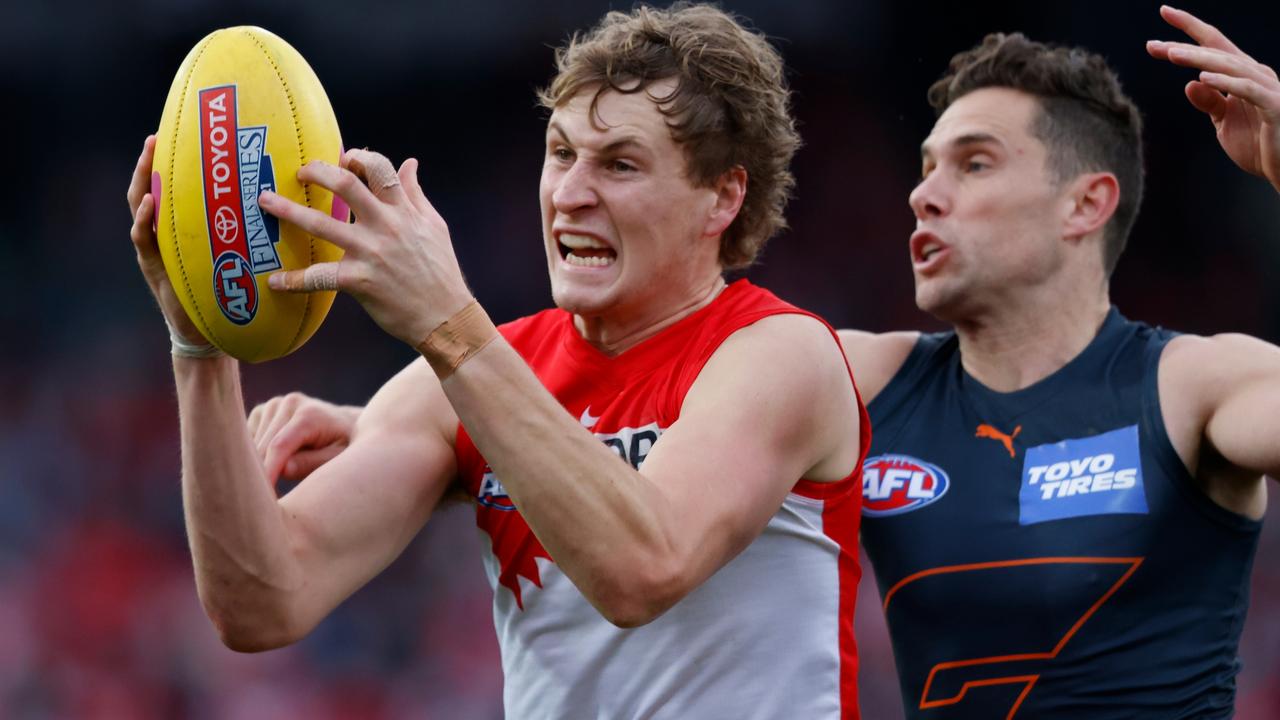 Jordan Dawson (L) of the Swans marks against Josh Kelly of the Giants during the 2021 AFL Second Elimination Final match between the Sydney Swans and the GWS Giants at University of Tasmania Stadium. Picture: Rob Blakers/Getty Images