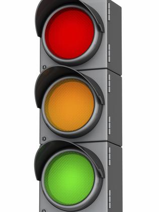 Grey traffic lights with red, yellow and green light