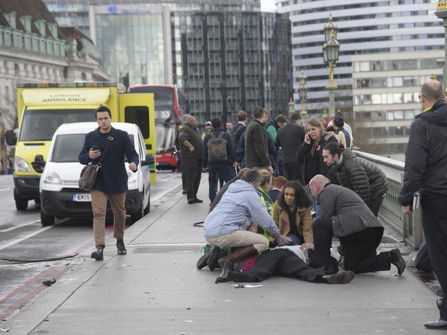 Injured people are assisted on Westminster Bridge in London. Picture: Reuters