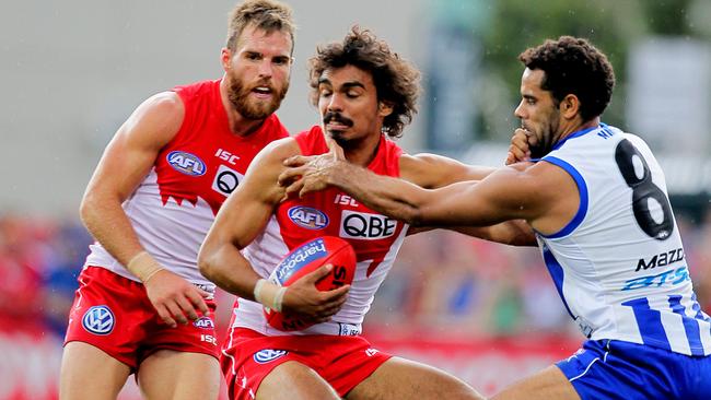 Tony Armstrong (centre) played 35 AFL games for three different clubs.