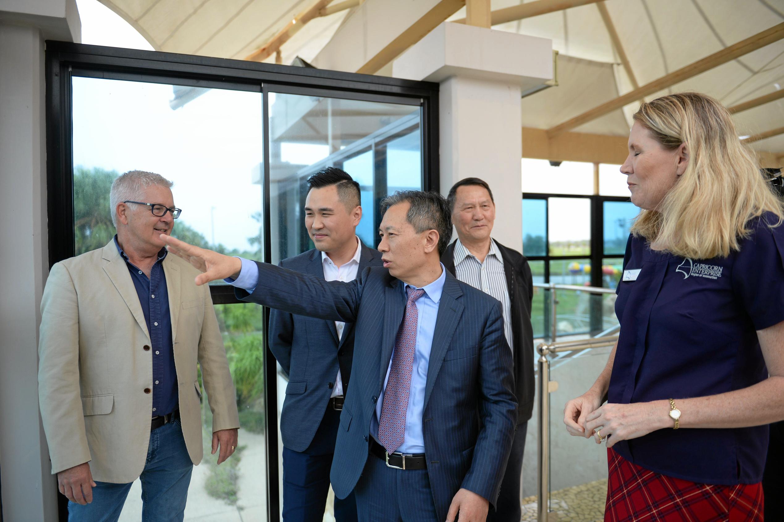 Ding Zoe Hong (centre) and his associates share their vision for the Keppel Cove resort site with Knight Frank Rockhamptoin and Regional principal (Pat O'Driscoll (left) and Capricorn Enterprise CEO Mary Carroll (right). Picture: Allan Reinikka