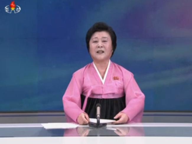 Major announcement ... The woman in pink on North Korean state TV. Picture: KRT via AP
