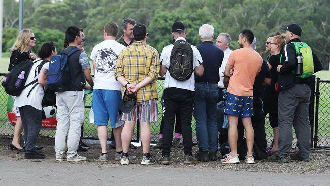 Teachers returning from a camp to Epping Boys High receive a briefing on Friday. Picture: John Feder