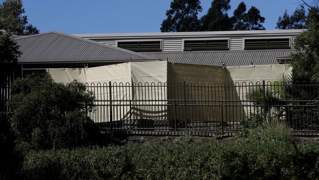 Temporary fencing and privacy screens have been installed at Newmarch house. Picture: Nikki Short