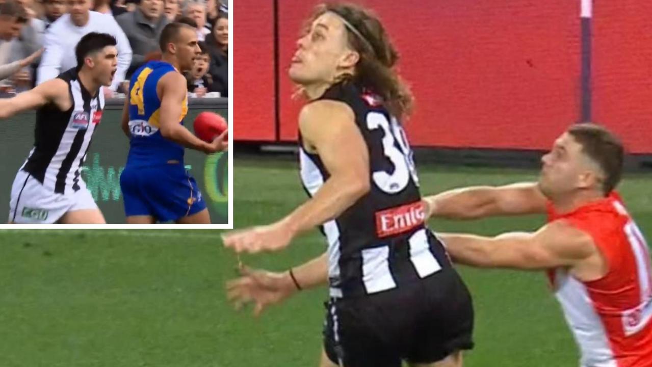 Tom Papley pushes Darcy Moore in a contest.