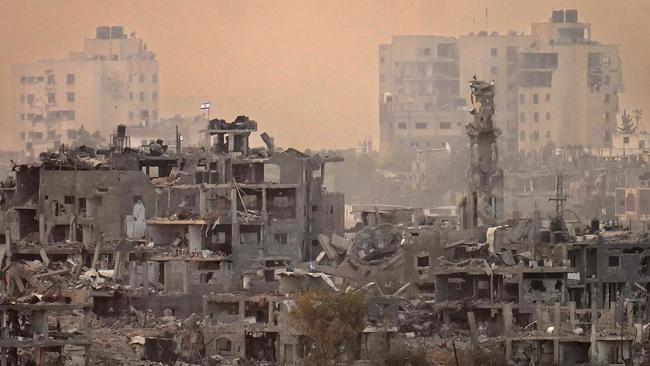 An Israeli flag flys on top of destroyed building next to a mosque in northern Gaza.