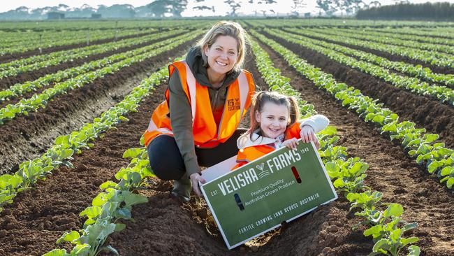 Catherine Velisha and five-year-old Mary Ryan from Corpus Christi Primary School in Werribee in the broccoli. Picture: Zoe Phillips