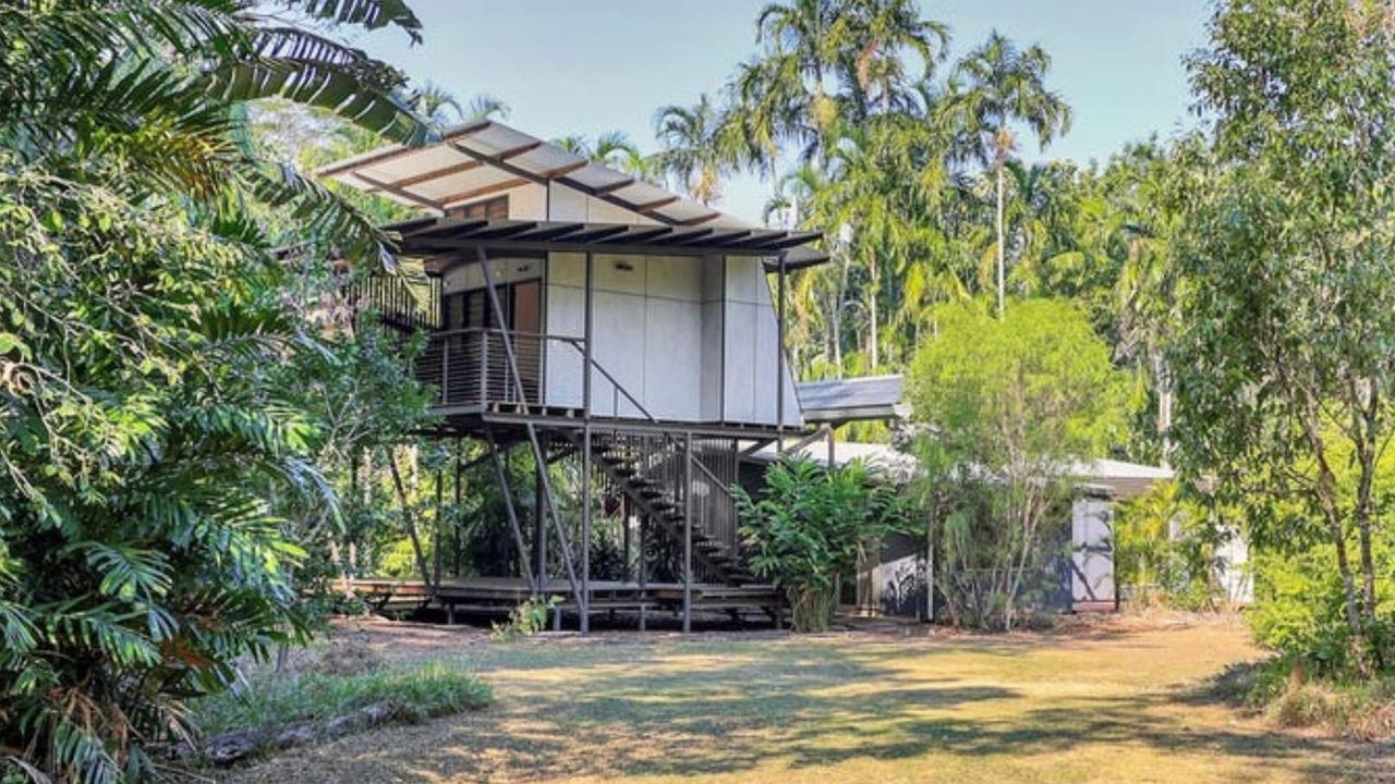 The listing highlights the property's "Tranquillity in the bush" setting, a stunning extension designed by Troppo Architects, an outdoor pavilion with 360-degree views, and a resort-style swimming pool.