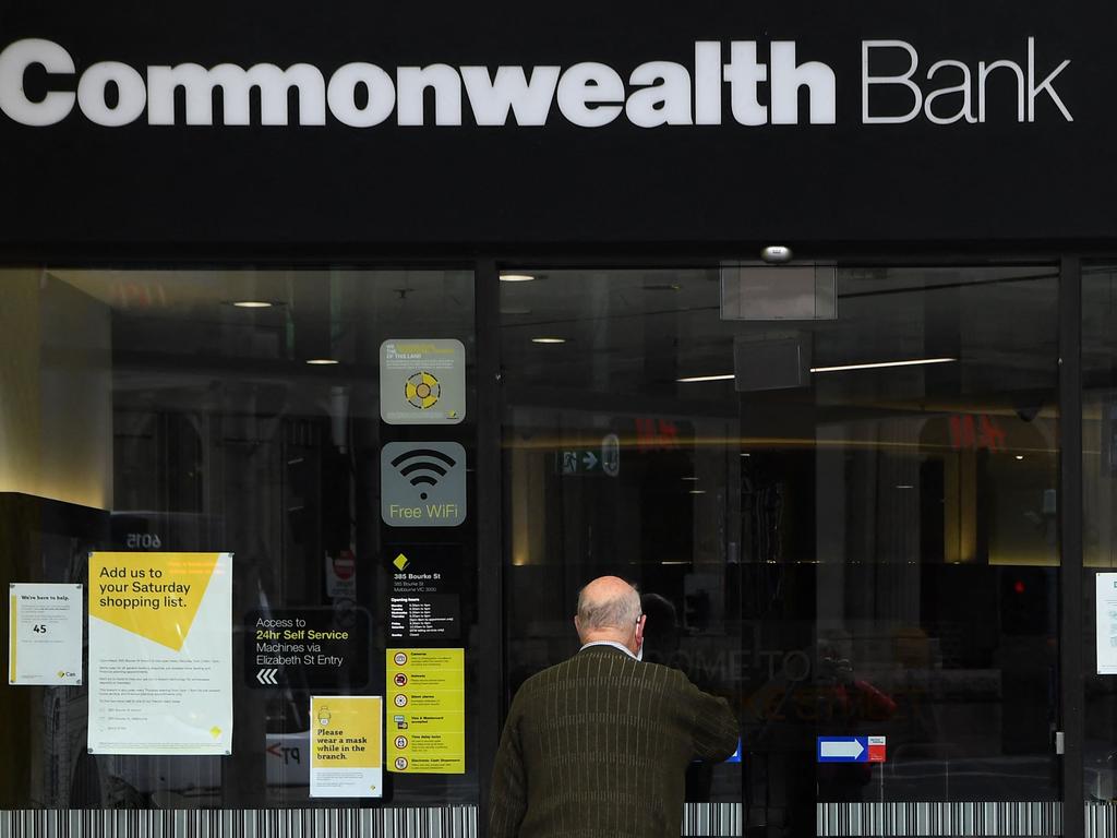 A man enters a branch of the Commonwealth Bank of Australia (CBA) in Melbourne on August 11, 2021 as the bank reported an almost 20 percent rise in full-year profits, citing the country's economic rebound after earlier pandemic lockdowns for the turnaround. (Photo by William WEST / AFP)