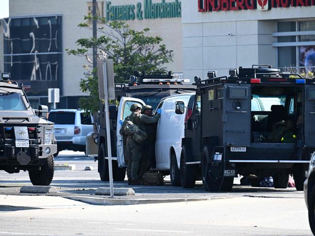 Police open the door of a van outside the site in Torrance, California, where the alleged suspect in the mass shooting is believed to be holed up. Picture: AFP