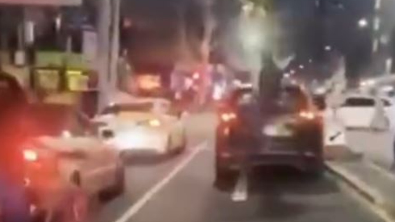 Wild moment driver, teen bike riders clash on Flinders St