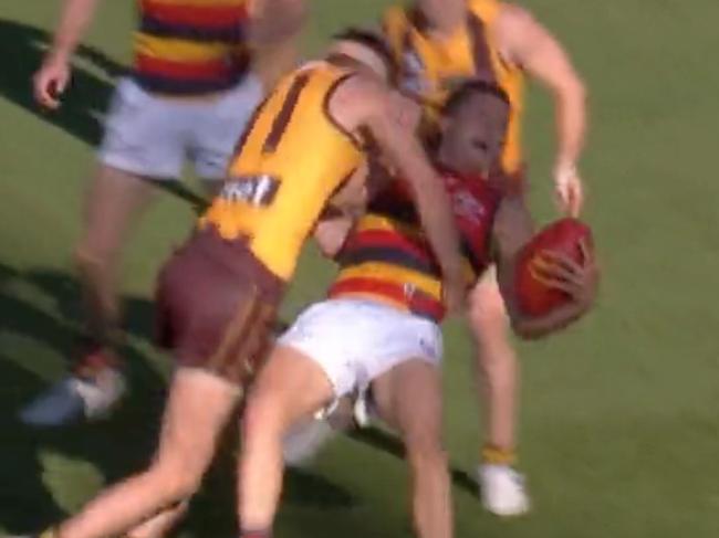 Hawthorn's Conor Nash lays a hit on Adelaide's Jake Soligo.