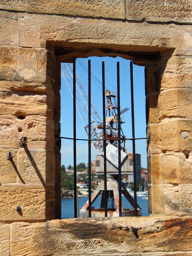 Looking through a window built by convict labour to one of Cockatoo Island's rusting cranes. Picture: Sarah Nicholson