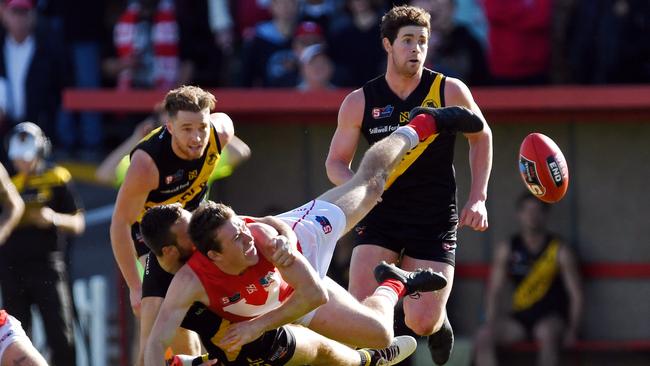 Glenelg's Cory Gregson takes North's Campbell Coombe to the ground in a challenging contest at Prospect Oval. Picture: Tom Huntley