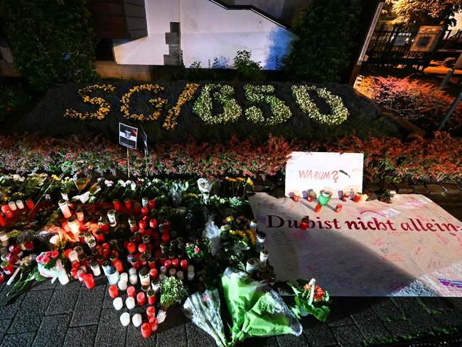 Candles and flowers and the inscription "Why? You are not alone" near the area where three people were killed and several injured during a knife attack during a city festival in Solingen. Germany. Picture: Ina Fassbender/AFP