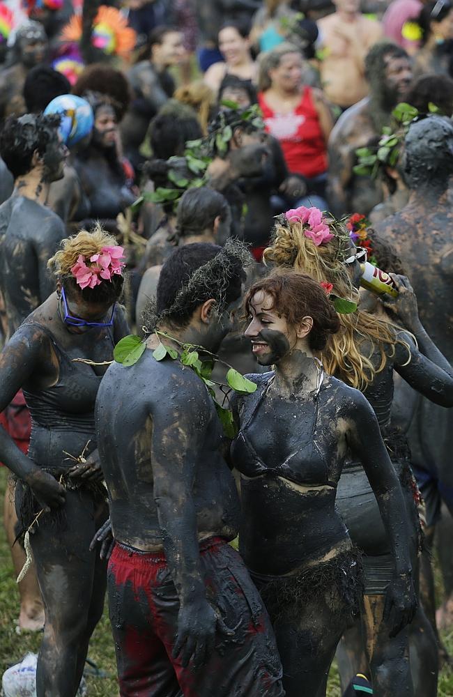 Mud-covered revellers dance at the "Bloco da Lama" in Paraty, Brazil.