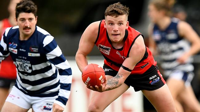 Samuel Wilson of Romsey handballs during the round 16 Riddell District Football Netball League 2023 Bendigo Bank Seniors match between Romsey and Macedon at Romsey Park in Romsey, Victoria on August 5, 2023. (Photo by Josh Chadwick)