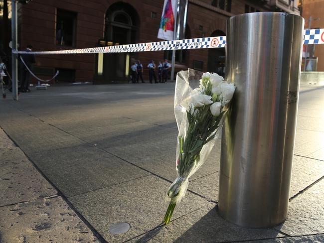 Flowers left by a man at Martin Place after the siege ended. Picture: John Grainger