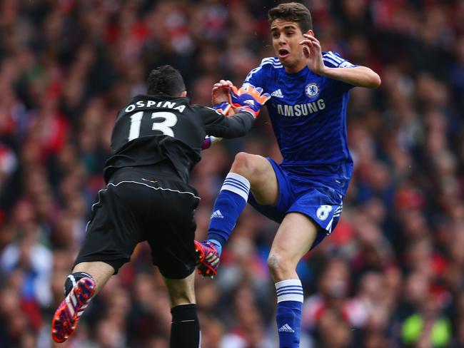 David Ospina of Arsenal and Oscar of Chelsea collide.