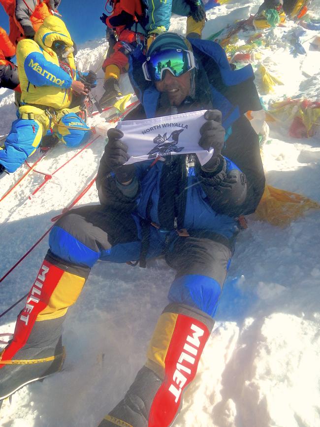 Terry Ledgard flying the North Whyalla Football Club flag at the summit of Mt Everest. Picture: Supplied